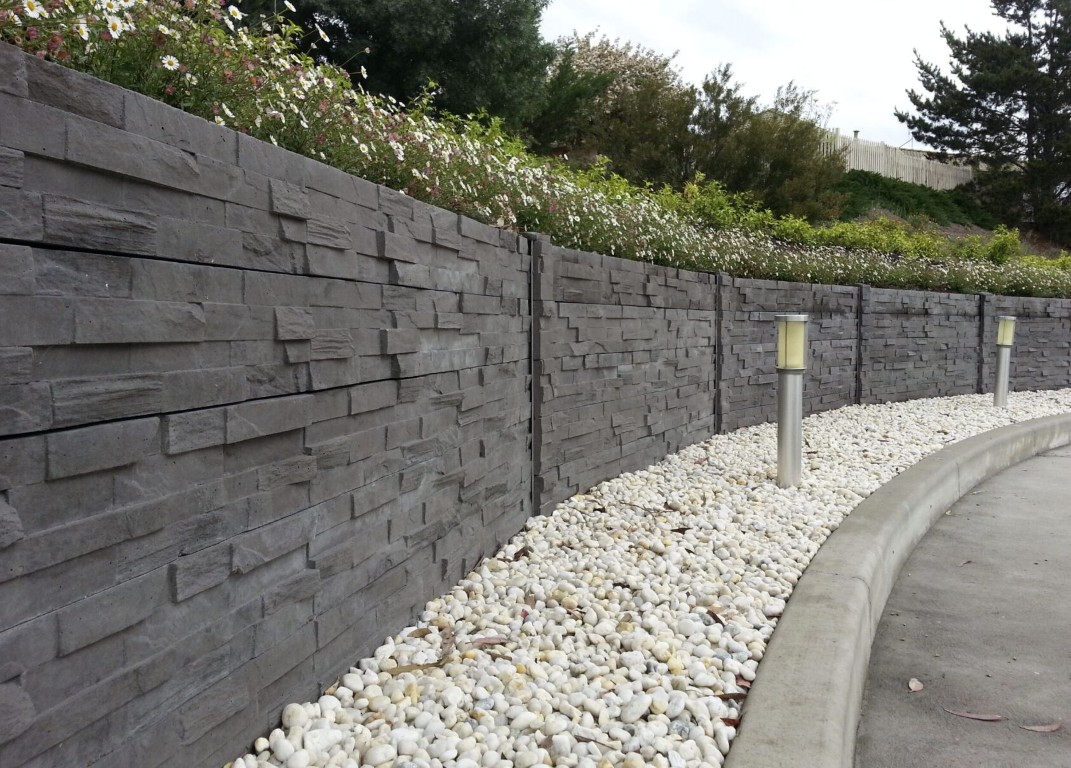 Commercial concrete retaining wall project with decorative stone finish in Bradenton, FL